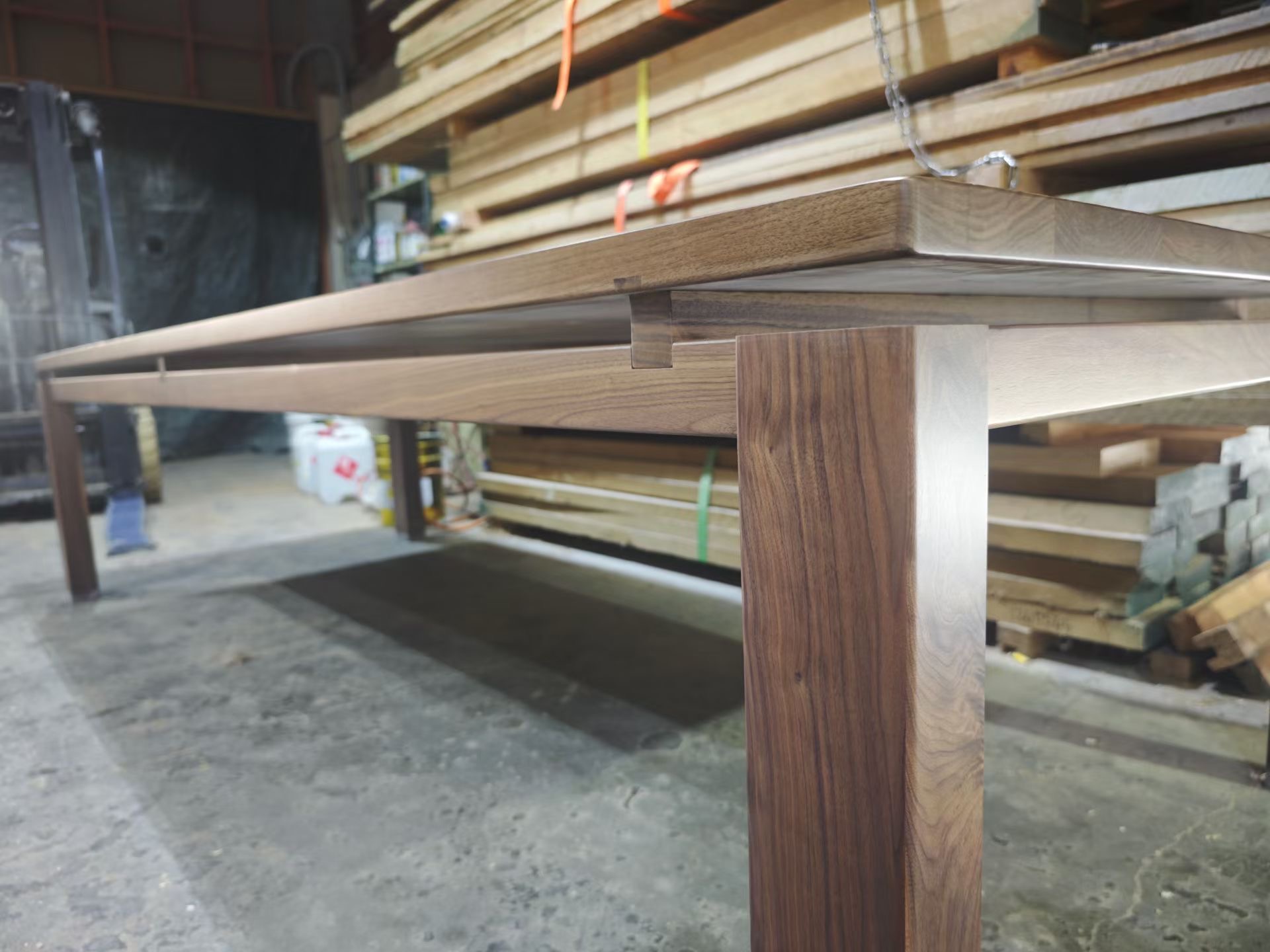 Solid walnut table joinery detail showing handcrafted precision