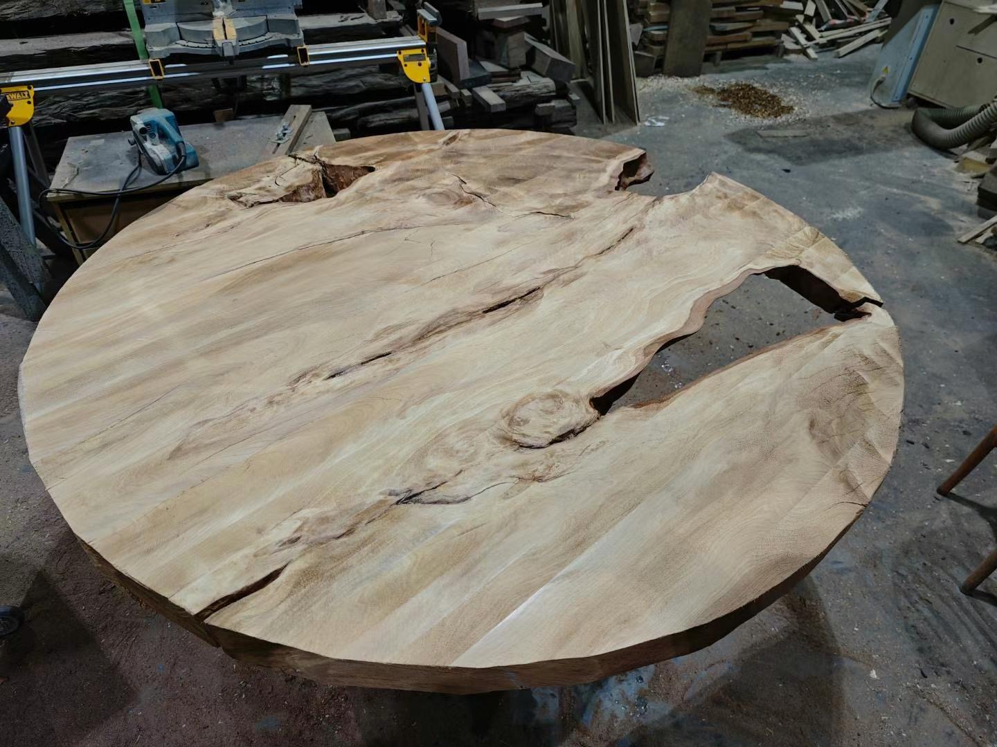Raw ancient Kauri slab in the workshop — 50,000-year-old timber with natural voids and character
