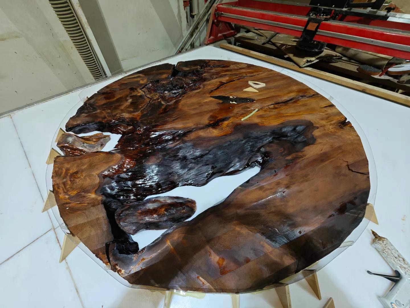 Kauri slab with dark epoxy resin filling the natural voids and crevices
