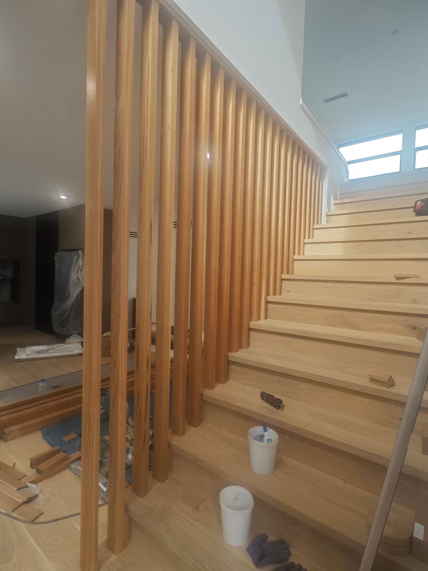 Full-height timber divider installation alongside staircase