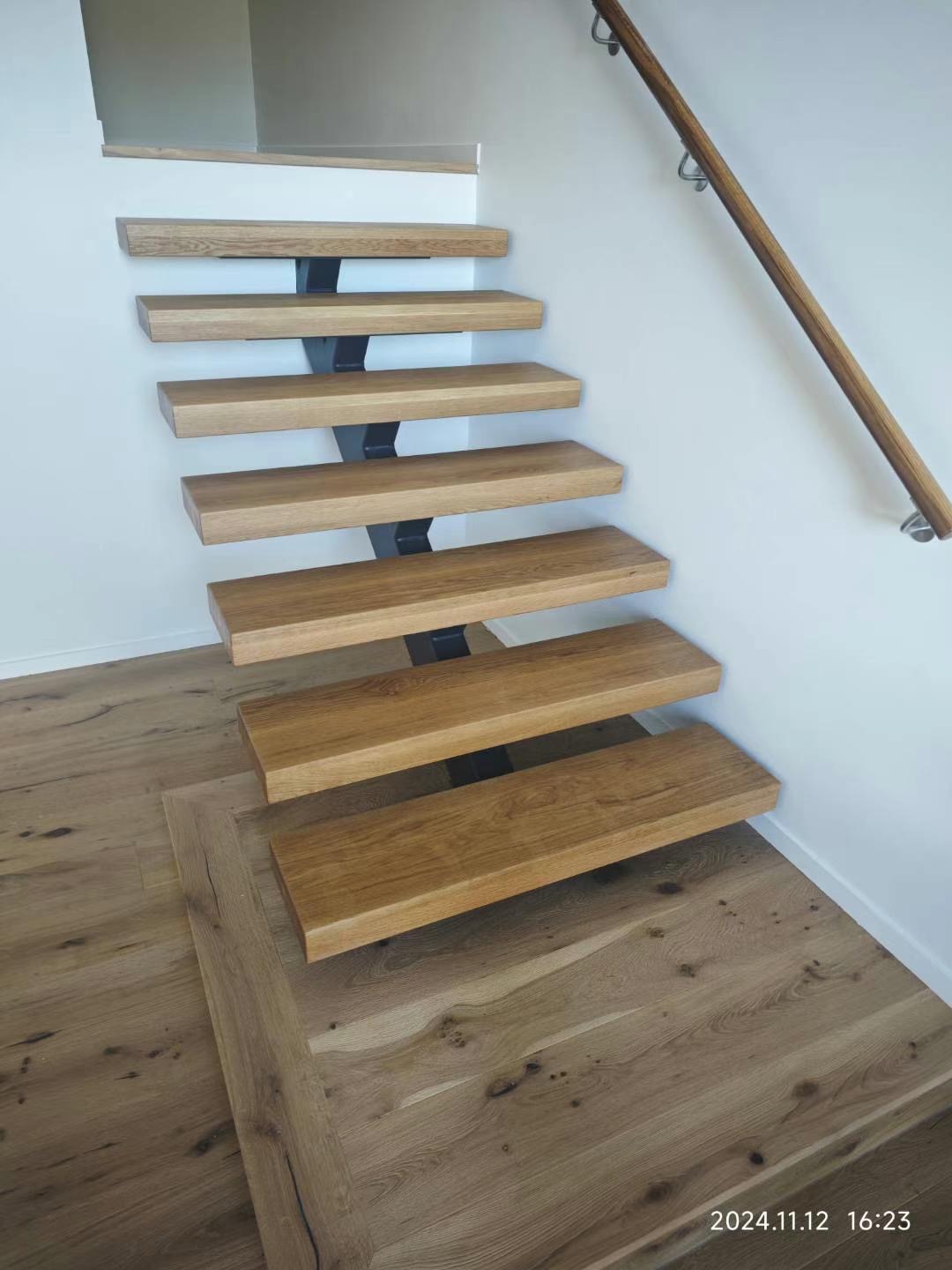 Floating oak staircase with steel central spine