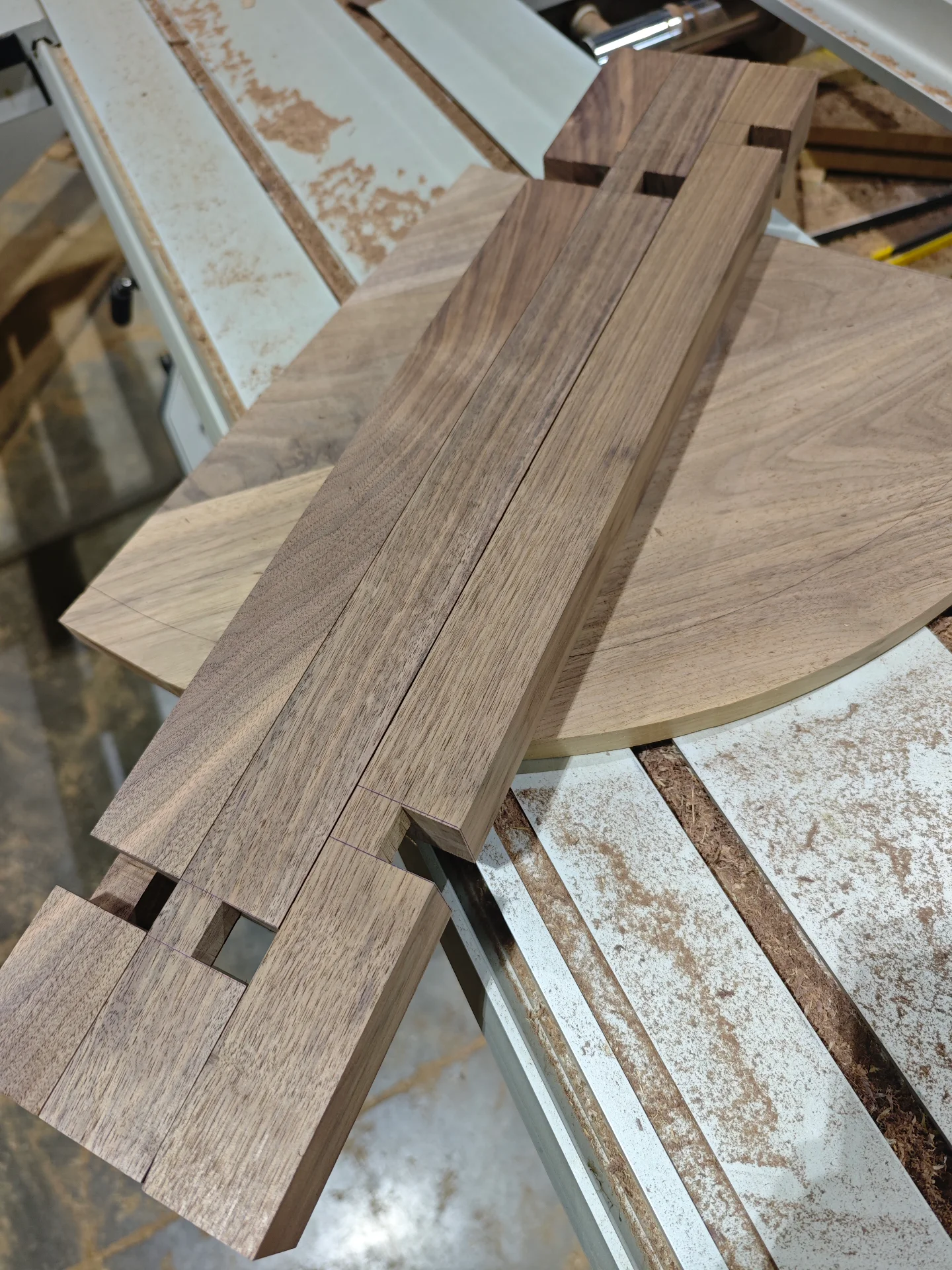 Milled black walnut boards laid out before assembly