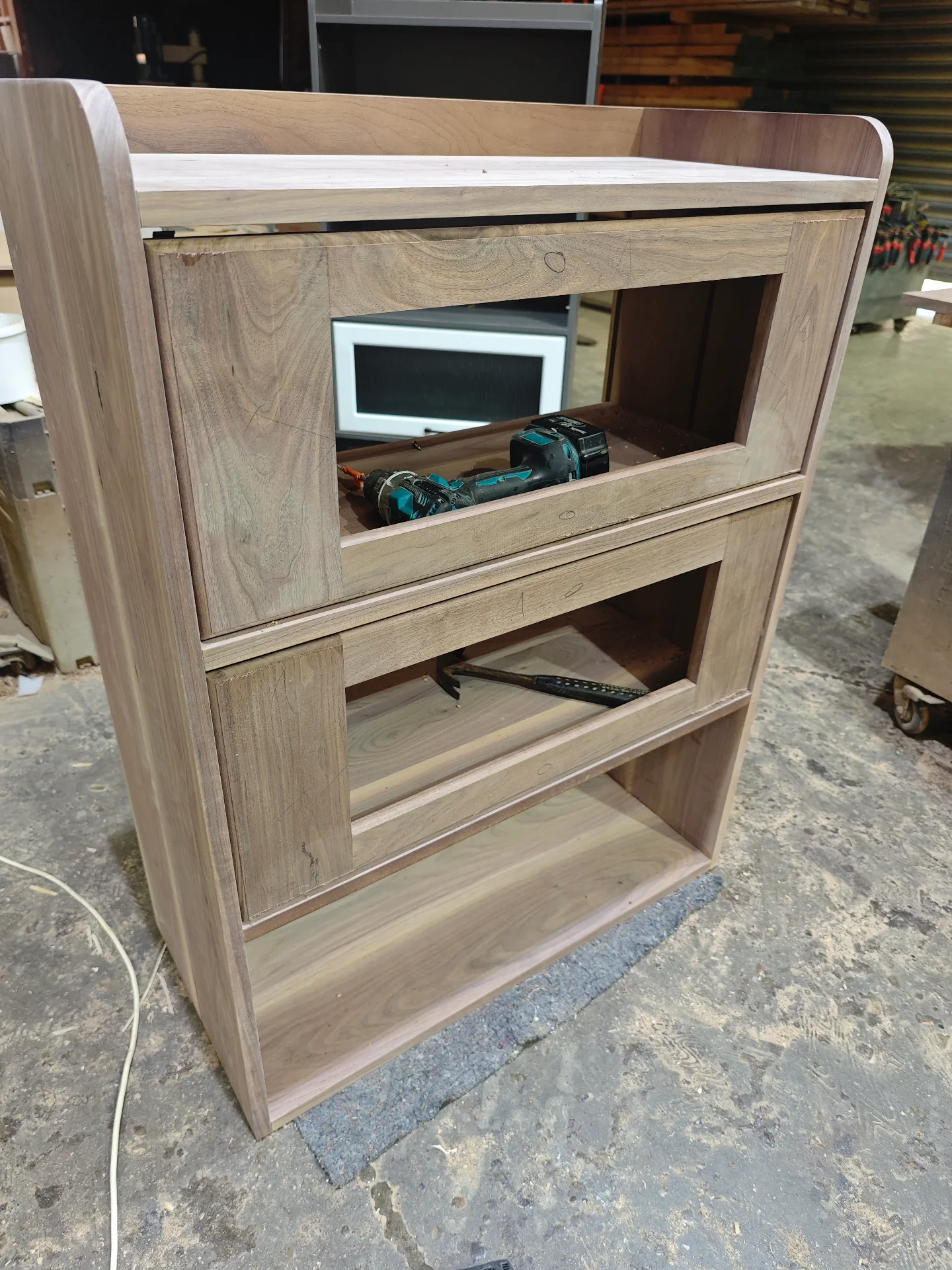 Raw black walnut cabinet with framed openings and shelves in progress