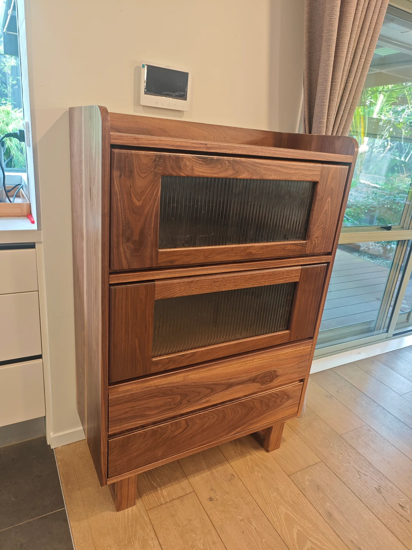 Finished black walnut cabinet with framed glass doors and drawer storage