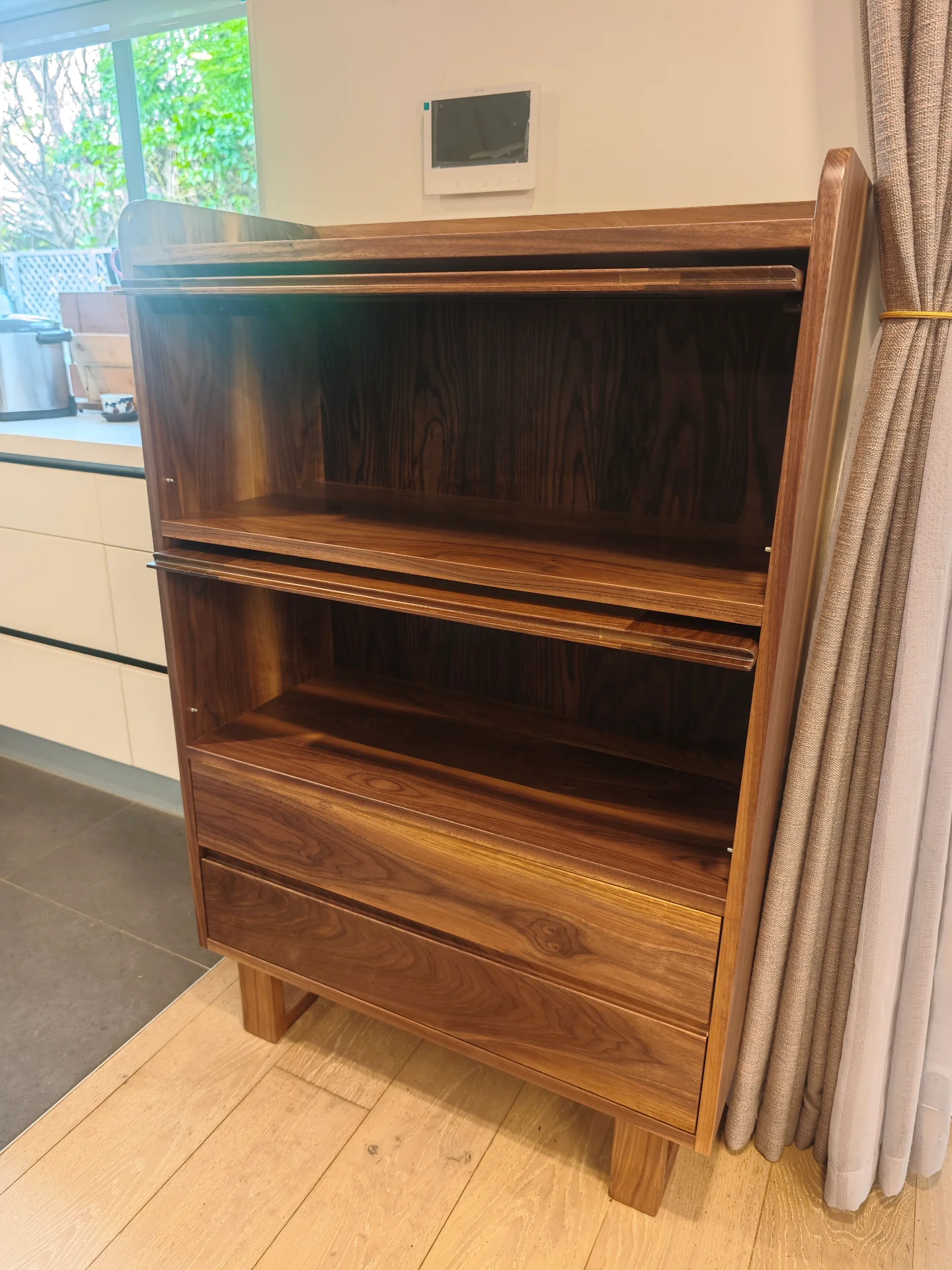 Side view of the completed black walnut cabinet showing depth and grain